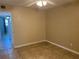 Bedroom features tile floors with neutral paint, fan, and an entrance to another room at 2434 Australia E Way # 22, Clearwater, FL 33763