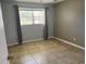 Bedroom with neutral walls and window with curtains, complete with tile flooring at 2434 Australia E Way # 22, Clearwater, FL 33763