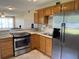 Well-lit kitchen with stainless steel refrigerator and appliances, plus a stylish breakfast bar at 2434 Australia E Way # 22, Clearwater, FL 33763