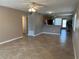 Open-concept living room featuring tile flooring and seamless transition to the breakfast bar and kitchen at 2434 Australia E Way # 22, Clearwater, FL 33763