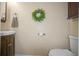 Bathroom with wood vanity, mirror, wall decor and toilet at 2529 Harn Blvd # 2, Clearwater, FL 33764