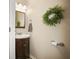 Half bathroom featuring a wood vanity, accent lighting, a mirror and a decorative wreath at 2529 Harn Blvd # 2, Clearwater, FL 33764