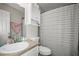 Cozy bathroom with a single sink vanity, toilet, shower and tub combination with storage at 2529 Harn Blvd # 2, Clearwater, FL 33764