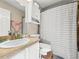 Cozy bathroom with a single sink vanity, toilet, shower and tub combination with storage at 2529 Harn Blvd # 2, Clearwater, FL 33764
