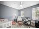 Neutral bedroom featuring a ceiling fan, window, changing table and bassinet at 2529 Harn Blvd # 2, Clearwater, FL 33764