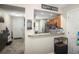 Open kitchen featuring a breakfast bar, tiled floors, and an archway view of the front entrance at 2529 Harn Blvd # 2, Clearwater, FL 33764