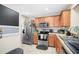 Well-lit kitchen with stainless steel appliances, wood cabinets and decor at 2529 Harn Blvd # 2, Clearwater, FL 33764