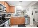 Kitchen showing stainless steel appliances and a view into another room at 2529 Harn Blvd # 2, Clearwater, FL 33764