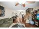 An open-concept living room with hardwood floors, a staircase, and an archway to the kitchen at 2529 Harn Blvd # 2, Clearwater, FL 33764