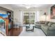 Inviting living room featuring hardwood floors, a comfortable sofa, and sliding glass doors to the backyard at 2529 Harn Blvd # 2, Clearwater, FL 33764