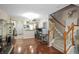 Open-concept living room featuring hardwood floors, a staircase, and an archway to the kitchen at 2529 Harn Blvd # 2, Clearwater, FL 33764