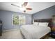 Comfortable main bedroom features a ceiling fan, window and queen bed at 2529 Harn Blvd # 2, Clearwater, FL 33764