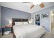 Comfortable main bedroom features a closet, ceiling fan, window and queen bed at 2529 Harn Blvd # 2, Clearwater, FL 33764