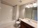 Bathroom featuring a tub and shower, toilet, vanity with sink and a large mirror at 26514 Chimney Spire Ln, Wesley Chapel, FL 33544