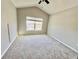 Bright bedroom with vaulted ceiling, ceiling fan, and a view to the outside at 26514 Chimney Spire Ln, Wesley Chapel, FL 33544