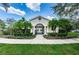 A view of the community clubhouse entrance surrounded by mature landscaping at 26514 Chimney Spire Ln, Wesley Chapel, FL 33544
