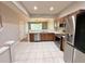 Stainless steel appliances and wood cabinets in a bright kitchen at 26514 Chimney Spire Ln, Wesley Chapel, FL 33544