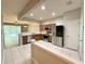 Open concept kitchen with stainless steel appliances and wood cabinets at 26514 Chimney Spire Ln, Wesley Chapel, FL 33544