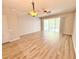Bright living room featuring wood floors, ceiling fan, and sliding glass doors to the outside at 26514 Chimney Spire Ln, Wesley Chapel, FL 33544