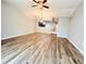 Open-concept living room with modern wood-look floors, recessed lighting and view to kitchen at 26514 Chimney Spire Ln, Wesley Chapel, FL 33544