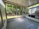 Screened porch with overhead lights and views of the outdoors at 26514 Chimney Spire Ln, Wesley Chapel, FL 33544
