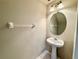 Cozy powder room featuring a pedestal sink and decorative lighting at 26514 Chimney Spire Ln, Wesley Chapel, FL 33544