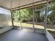 Enclosed screened porch with views to the backyard, offering an extension of outdoor living at 26514 Chimney Spire Ln, Wesley Chapel, FL 33544