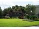 Community sign, 'The Bay at Cypress Creek' with surrounding landscaping and lawn at 26514 Chimney Spire Ln, Wesley Chapel, FL 33544