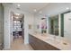 Modern bathroom featuring dual sinks, a large mirror, and a walk-in closet view at 301 1St S St # 2305, St Petersburg, FL 33701
