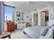 Modern bedroom with large window, dresser, and closet and bathroom access at 301 1St S St # 2305, St Petersburg, FL 33701