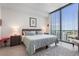 Bright bedroom featuring a large window with city views, a comfortable bed, and stylish decor at 301 1St S St # 2305, St Petersburg, FL 33701