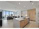 Open-concept kitchen featuring a large island and stainless steel appliances overlooking living area with city views at 301 1St S St # 2305, St Petersburg, FL 33701