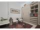 Bright office with built-in shelving, wine rack, decorative rug, and two comfortable chairs at 301 1St S St # 2305, St Petersburg, FL 33701