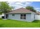 Large, green backyard with blue home and brown roof at 32201 Brookstone Dr, Wesley Chapel, FL 33545