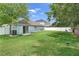 Large, green backyard with white fence and blue home at 32201 Brookstone Dr, Wesley Chapel, FL 33545