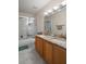 Bathroom with a double sink vanity, granite countertop, and tiled floor and shower at 32201 Brookstone Dr, Wesley Chapel, FL 33545
