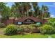A brick sign reads 'The Crossings' surrounded by landscaping, marking the entrance to a well-maintained community at 32201 Brookstone Dr, Wesley Chapel, FL 33545