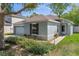 Well-kept single-story home with lush landscaping, a two-car garage, and a welcoming front entrance at 32201 Brookstone Dr, Wesley Chapel, FL 33545