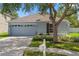 Inviting single-story home with a well-maintained lawn, mature trees, and a cozy curb appeal at 32201 Brookstone Dr, Wesley Chapel, FL 33545