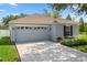 Charming single-story home with a two-car garage, manicured landscaping, and neutral color palette at 32201 Brookstone Dr, Wesley Chapel, FL 33545