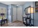 Entryway with tile flooring, neutral walls, and decorative mirror and lighting fixture at 32201 Brookstone Dr, Wesley Chapel, FL 33545