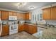 Modern kitchen with granite countertops, white appliances, and plenty of natural light at 32201 Brookstone Dr, Wesley Chapel, FL 33545