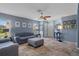 Spacious living room with tile flooring, neutral walls, and ample natural light from the window at 32201 Brookstone Dr, Wesley Chapel, FL 33545
