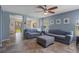 Bright living room with tile flooring, comfortable seating, and a view of the outdoor patio at 32201 Brookstone Dr, Wesley Chapel, FL 33545