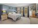 Spacious main bedroom with blue accent wall, carpeted floor, and two dressers at 32201 Brookstone Dr, Wesley Chapel, FL 33545