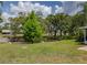 Picturesque backyard with a pond, mature trees, and a well-maintained lawn, offering a serene outdoor space at 333 Bay Pl, Safety Harbor, FL 34695