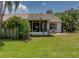 Backyard with a screened in porch, a hanging swing, and ample green space at 333 Bay Pl, Safety Harbor, FL 34695