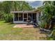 Beautiful backyard with a screened in porch, hanging swing, and patio area at 333 Bay Pl, Safety Harbor, FL 34695