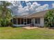 Backyard with a screened in porch, a hanging swing, and lush green grass at 333 Bay Pl, Safety Harbor, FL 34695