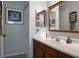 Well-lit bathroom featuring a vanity with a white countertop and a framed mirror at 333 Bay Pl, Safety Harbor, FL 34695